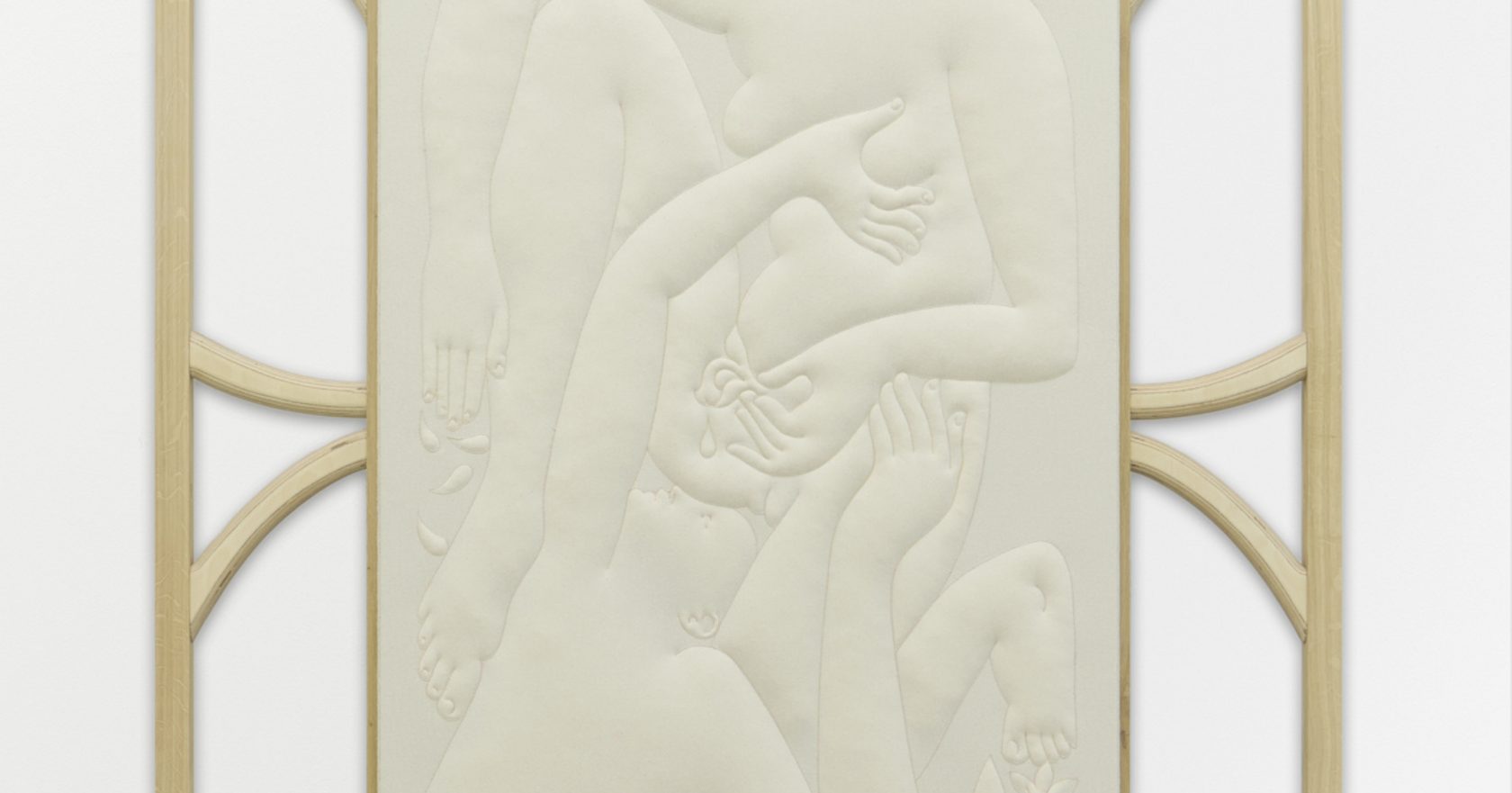 A pale relief of entwined limbs and open hands, raised in soft stitched contours and held in a slim wooden frame with curved braces.